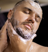 man washing his beard